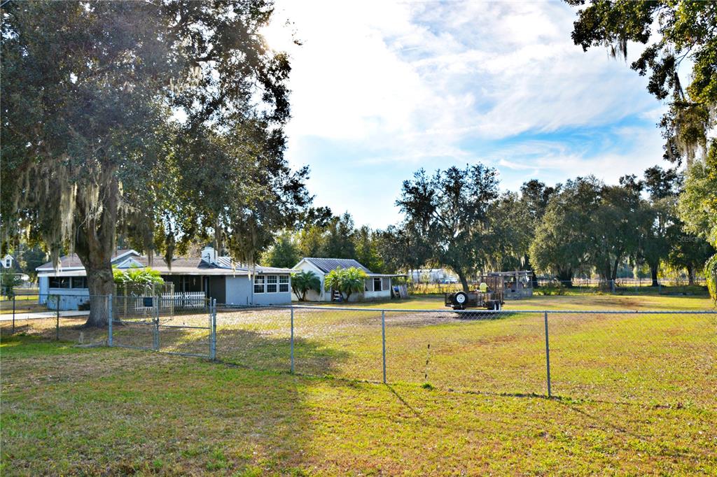 5528 Cherry Road Lakeland, FL 33810 - Photo 41 of 47 a view of a swimming pool with a bench and trees