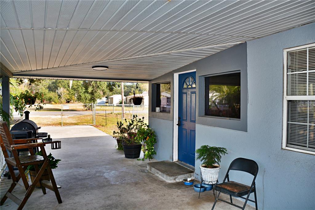 5528 Cherry Road Lakeland, FL 33810 - Photo 6 of 47 a view of a porch with chairs and potted plants