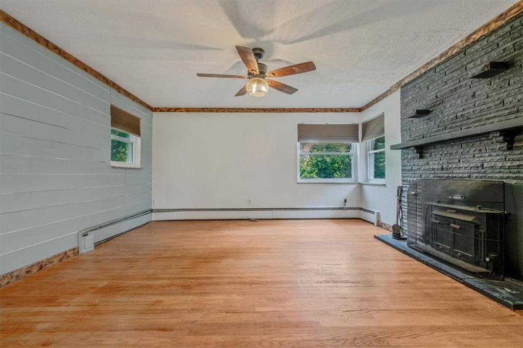 104 Linden Road Canonsburg, PA 15317 - Photo 16 of 48 a view of a livingroom with a fireplace a ceiling fan and window