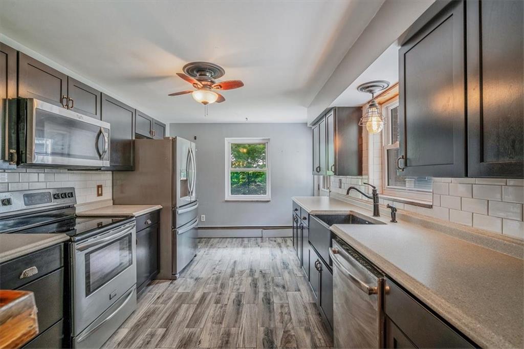 104 Linden Road Canonsburg, PA 15317 - Photo 4 of 48 a kitchen with stainless steel appliances a sink dishwasher a stove top oven a refrigerator with island and chairs