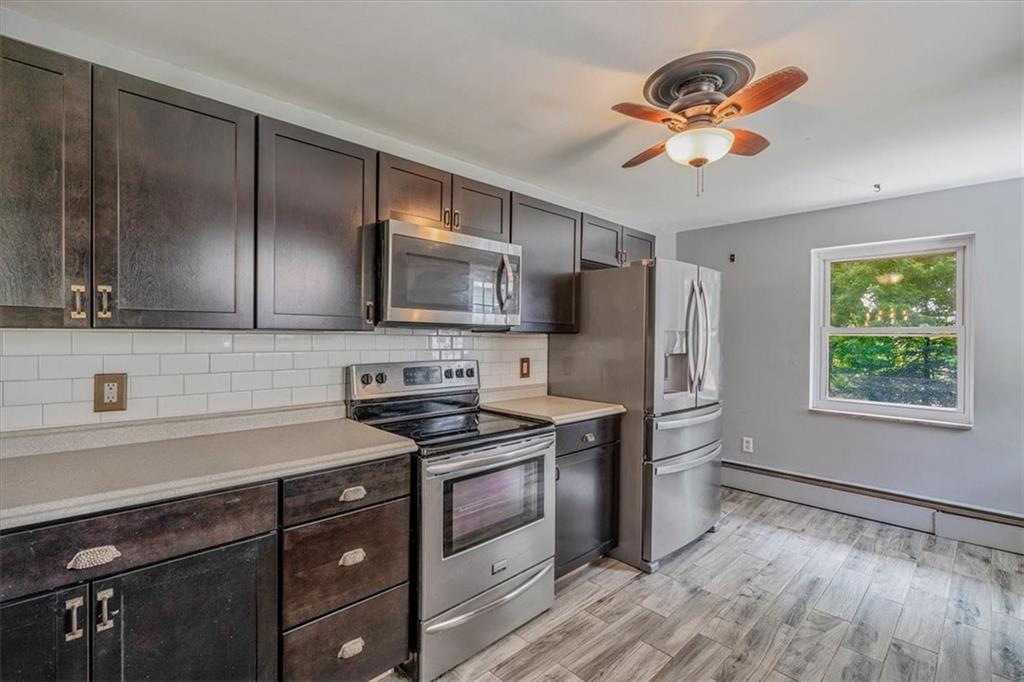 104 Linden Road Canonsburg, PA 15317 - Photo 5 of 48 a kitchen with stainless steel appliances granite countertop a stove a sink dishwasher a refrigerator and microwave with wooden floor