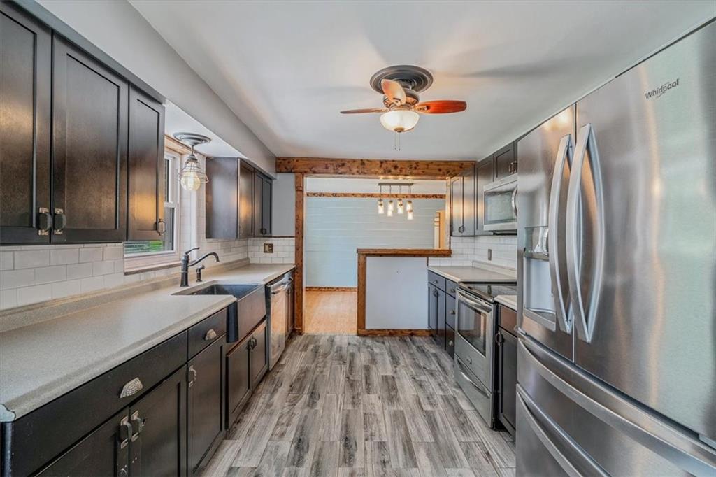 104 Linden Road Canonsburg, PA 15317 - Photo 9 of 48 a kitchen with granite countertop stainless steel appliances a sink stove and refrigerator