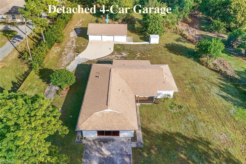 an aerial view of a house with swimming pool and wooden fence