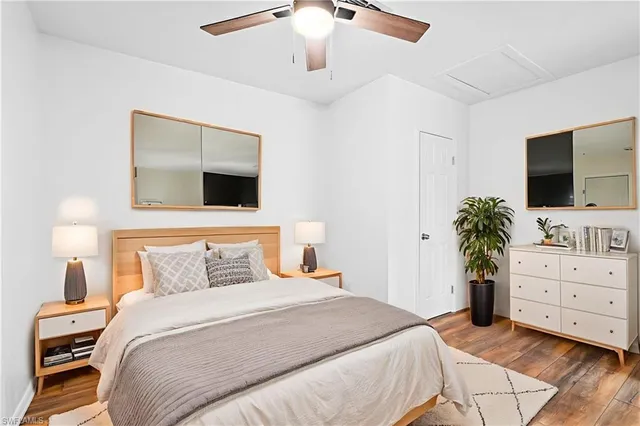 a bedroom with a bed and a flat tv screen on dresser