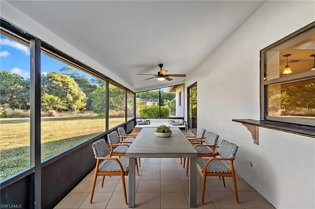 a view of a dining room with furniture large windows and wooden floor