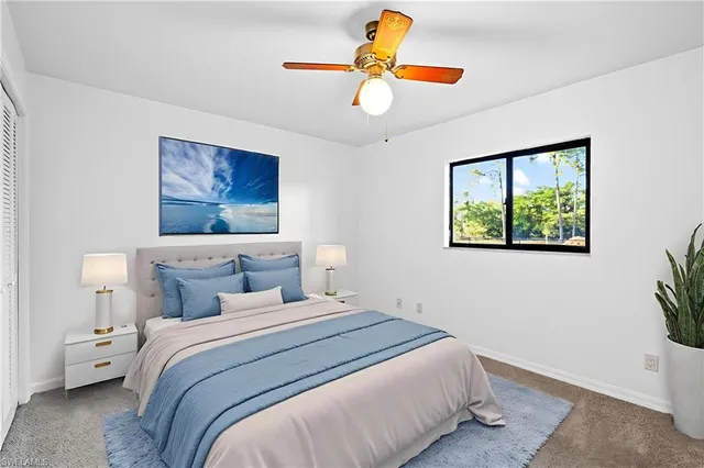 a bedroom with a bed and a painting on the wall