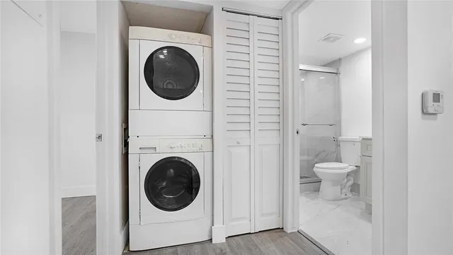 a bathroom with a sink toilet a mirror and shower