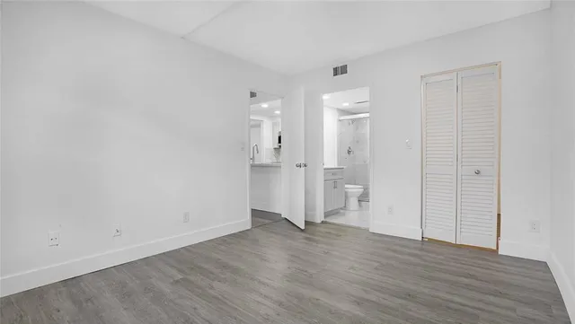 a view of a brick house with a yard and plants