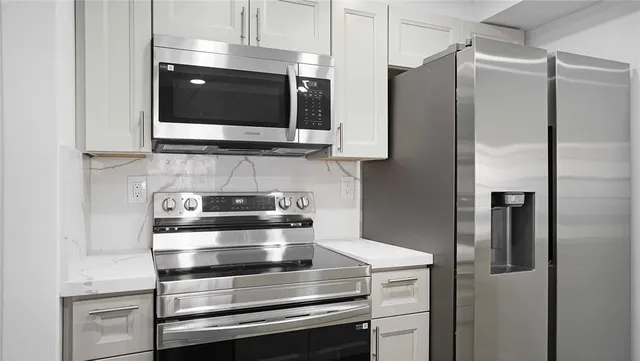a kitchen with stainless steel appliances and wooden cabinets