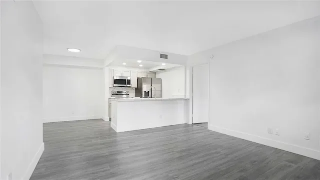 a kitchen with a sink and a stove top oven