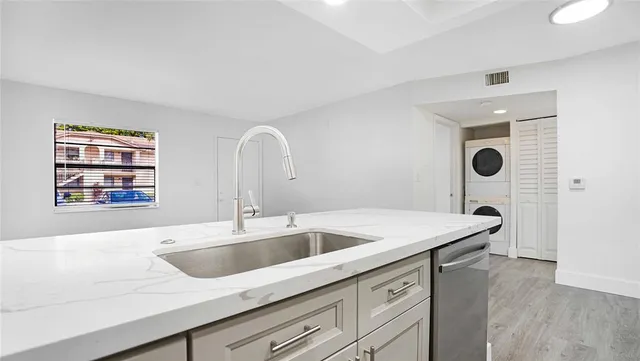 a kitchen with a sink and a refrigerator