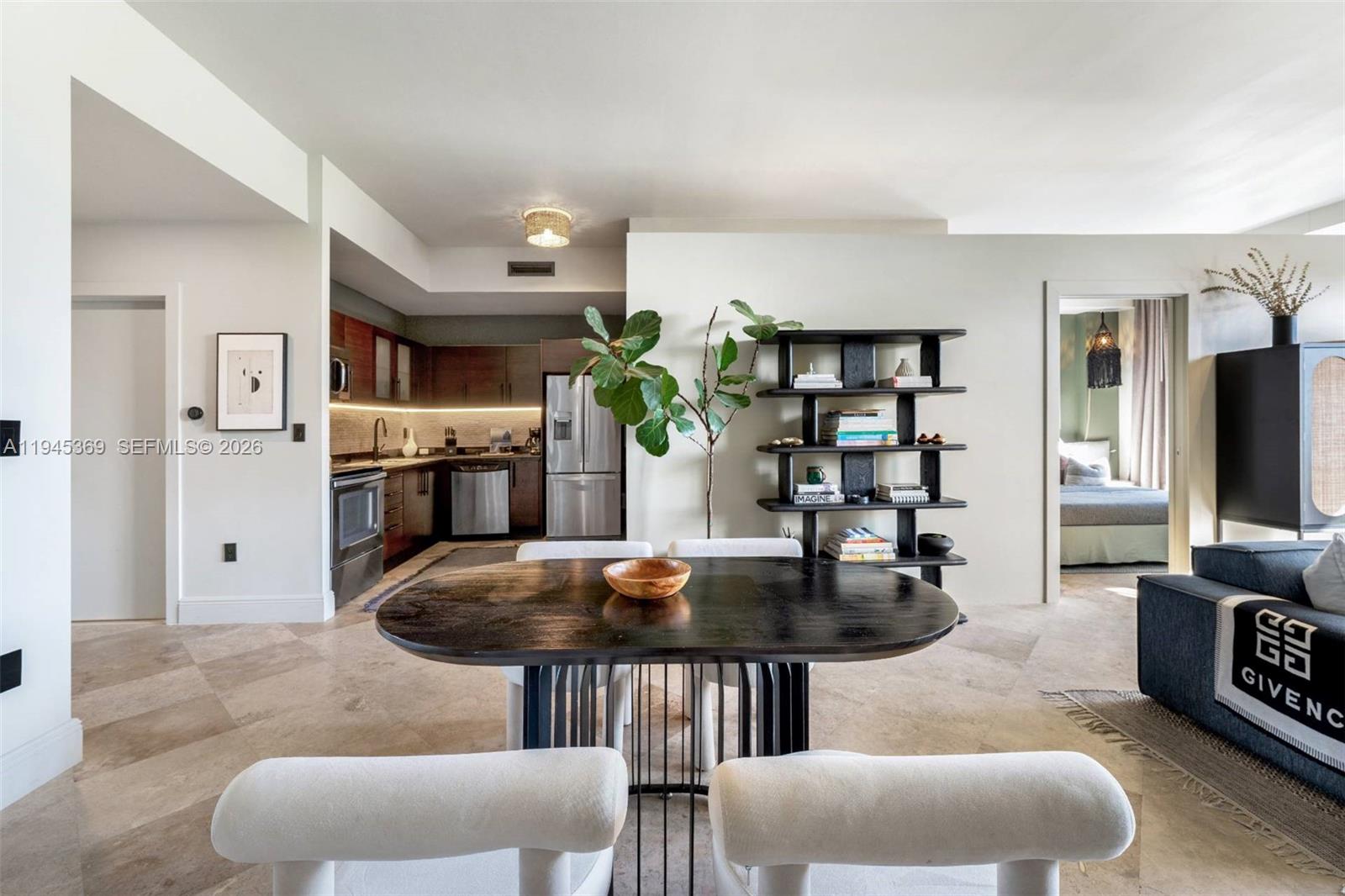 3250 Grand Avenue, Unit 306 Miami, FL 33133 - Photo 12 of 32 a living room with furniture a flat screen tv and kitchen view