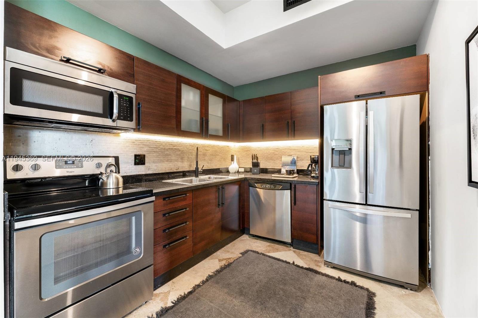 3250 Grand Avenue, Unit 306 Miami, FL 33133 - Photo 15 of 32 a kitchen with stainless steel appliances granite countertop a refrigerator stove and sink