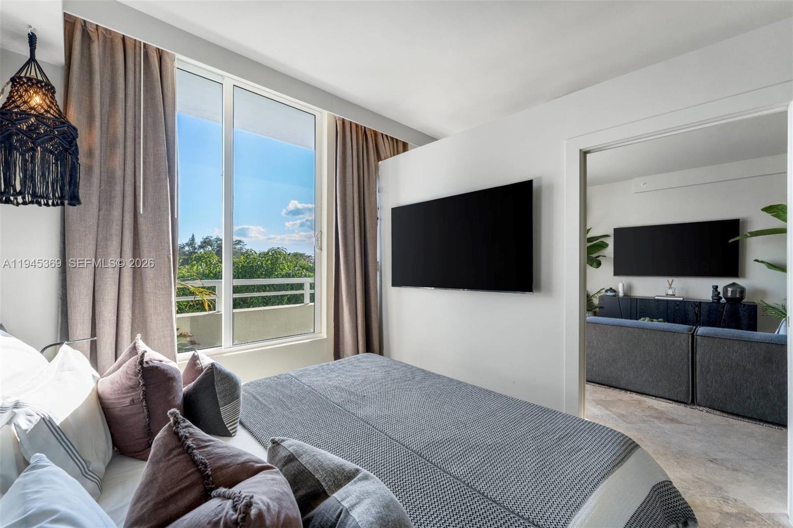 3250 Grand Avenue, Unit 306 Miami, FL 33133 - Photo 18 of 32 a bedroom with a bed and a flat screen tv