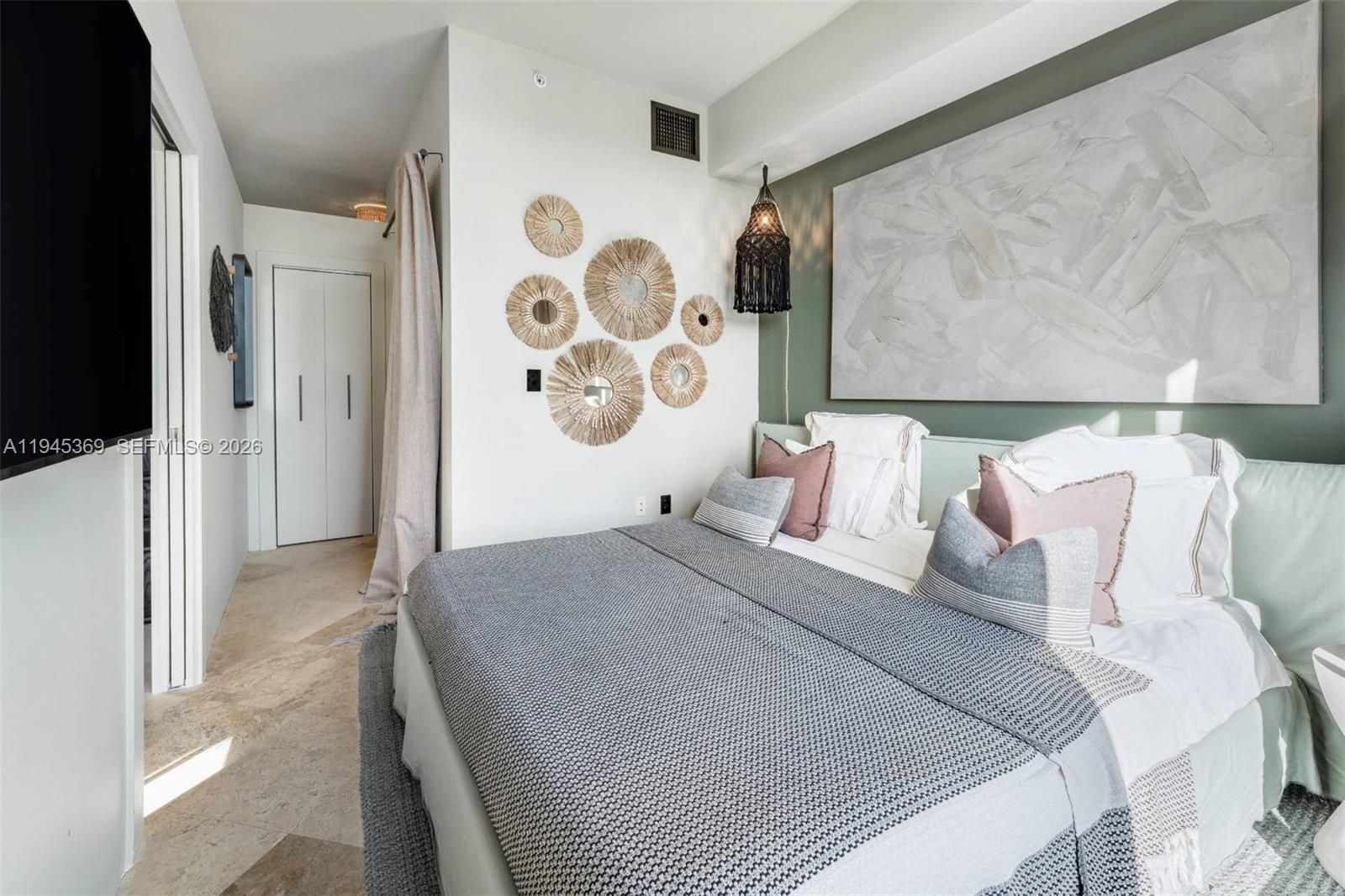 3250 Grand Avenue, Unit 306 Miami, FL 33133 - Photo 20 of 32 a bedroom with a bed and painting on the wall