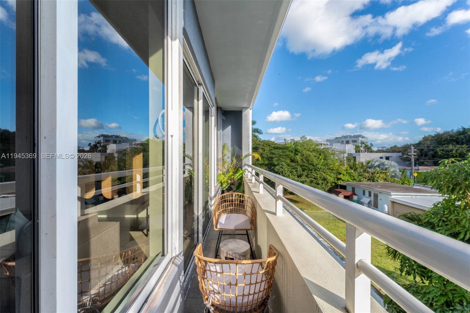 3250 Grand Avenue, Unit 306 Miami, FL 33133 - Photo 29 of 32 a view of a balcony with furniture and wooden floor