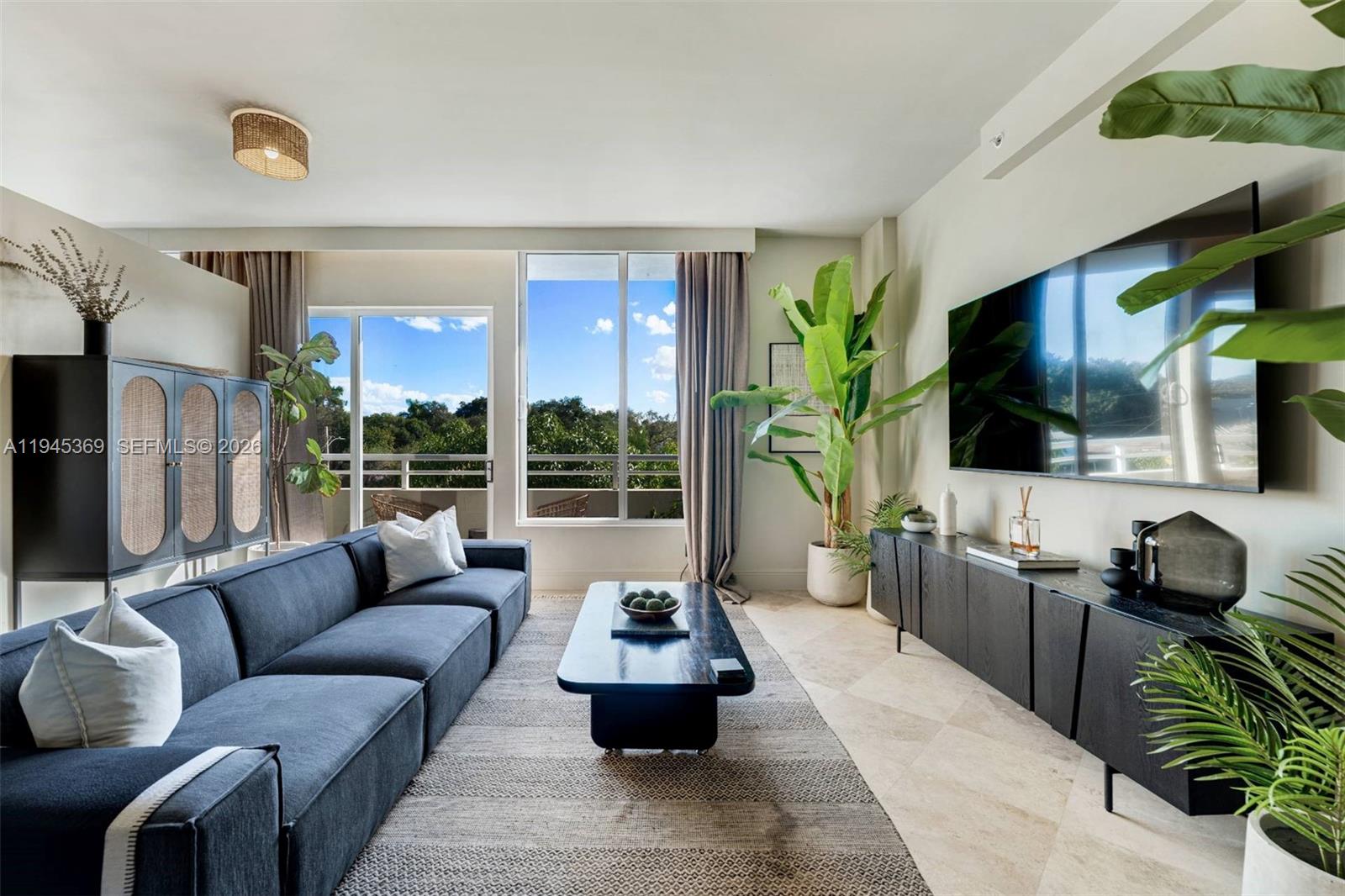 3250 Grand Avenue, Unit 306 Miami, FL 33133 - Photo 4 of 32 a living room with furniture and a flat screen tv