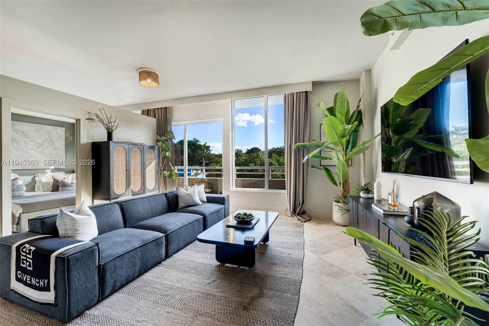 3250 Grand Avenue, Unit 306 Miami, FL 33133 - Photo 5 of 32 a living room with furniture and a flat screen tv