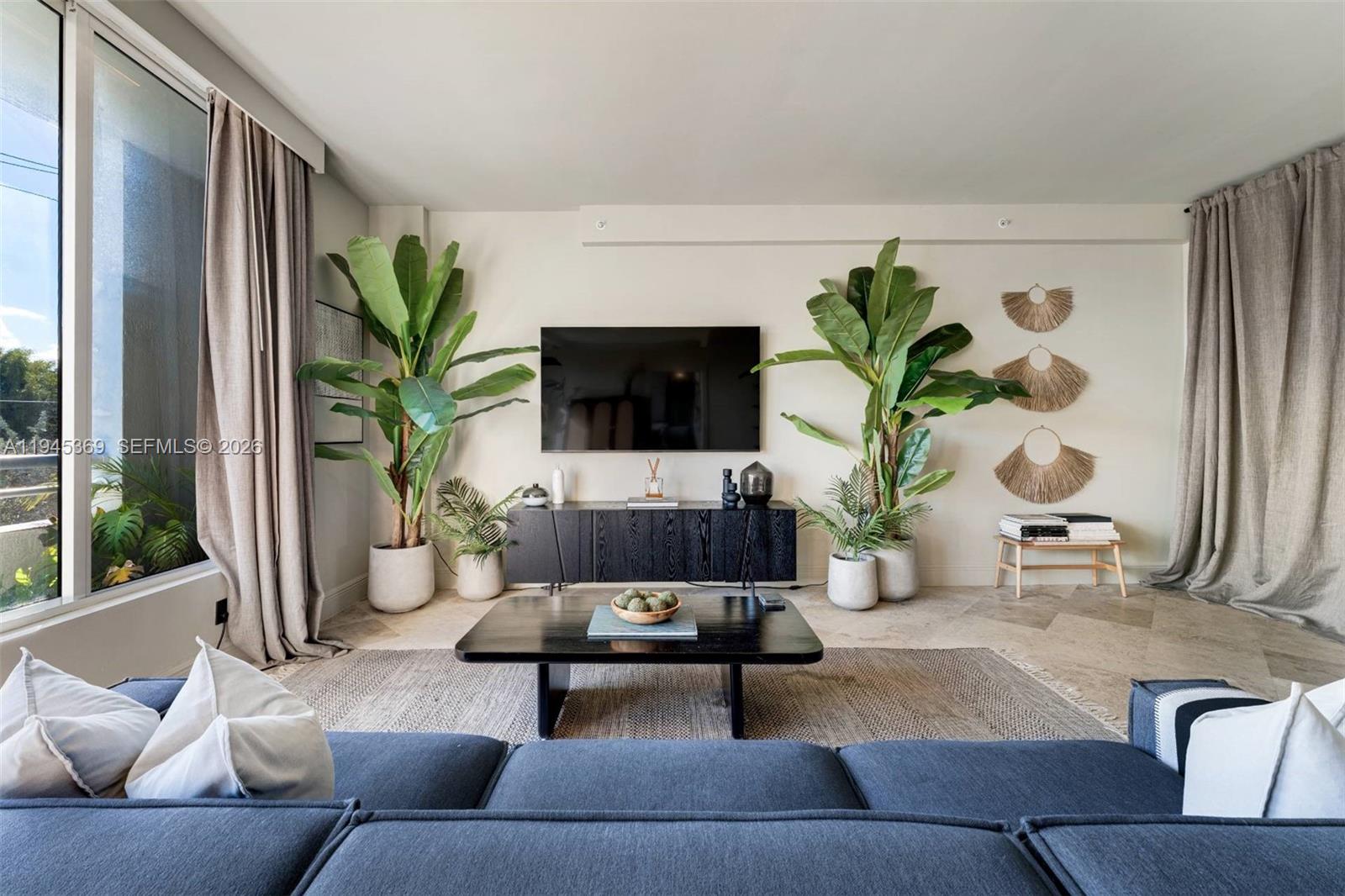 3250 Grand Avenue, Unit 306 Miami, FL 33133 - Photo 6 of 32 a living room with furniture potted plant and a large window