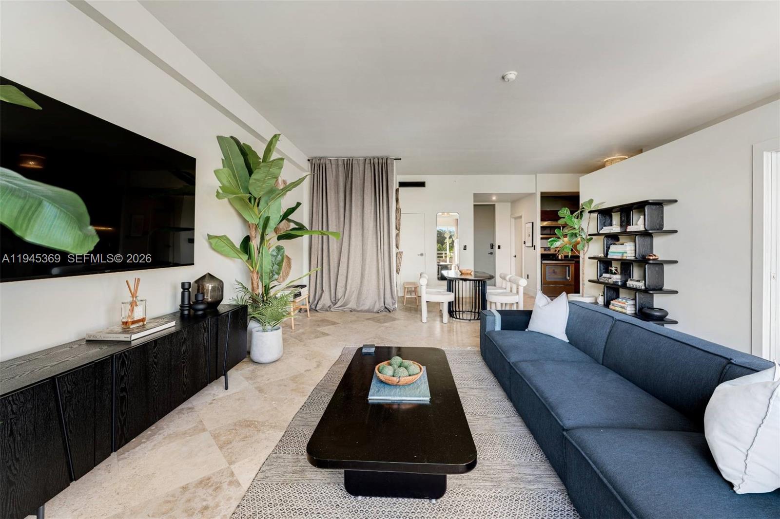 3250 Grand Avenue, Unit 306 Miami, FL 33133 - Photo 8 of 32 a living room with furniture and a flat screen tv