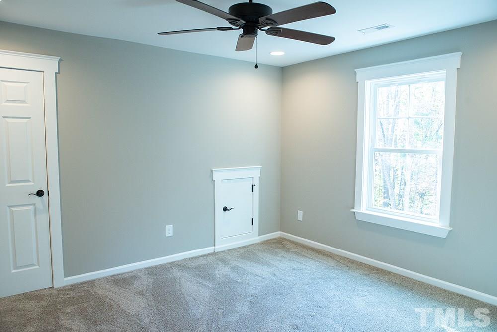 1426 Bowmantown Road Roxboro, NC 27574 - Photo 19 of 28 an empty room with a window and a fan