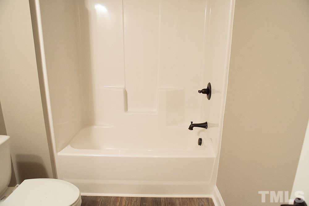 1426 Bowmantown Road Roxboro, NC 27574 - Photo 22 of 28 a bathroom with a bathtub and a toilet
