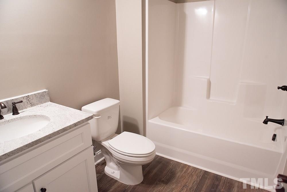 1426 Bowmantown Road Roxboro, NC 27574 - Photo 23 of 28 a bathroom with a sink a toilet and bathtub