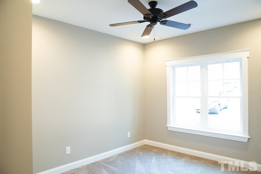 1426 Bowmantown Road Roxboro, NC 27574 - Photo 24 of 28 an empty room with a window and a fan