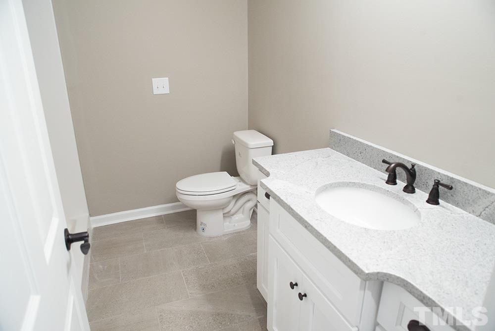 1426 Bowmantown Road Roxboro, NC 27574 - Photo 27 of 28 a bathroom with a sink toilet and vanity
