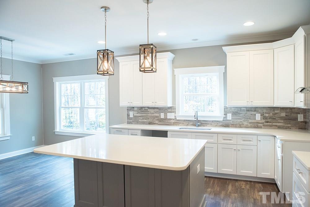 1426 Bowmantown Road Roxboro, NC 27574 - Photo 9 of 28 a kitchen with stainless steel appliances granite countertop a sink a window and cabinets