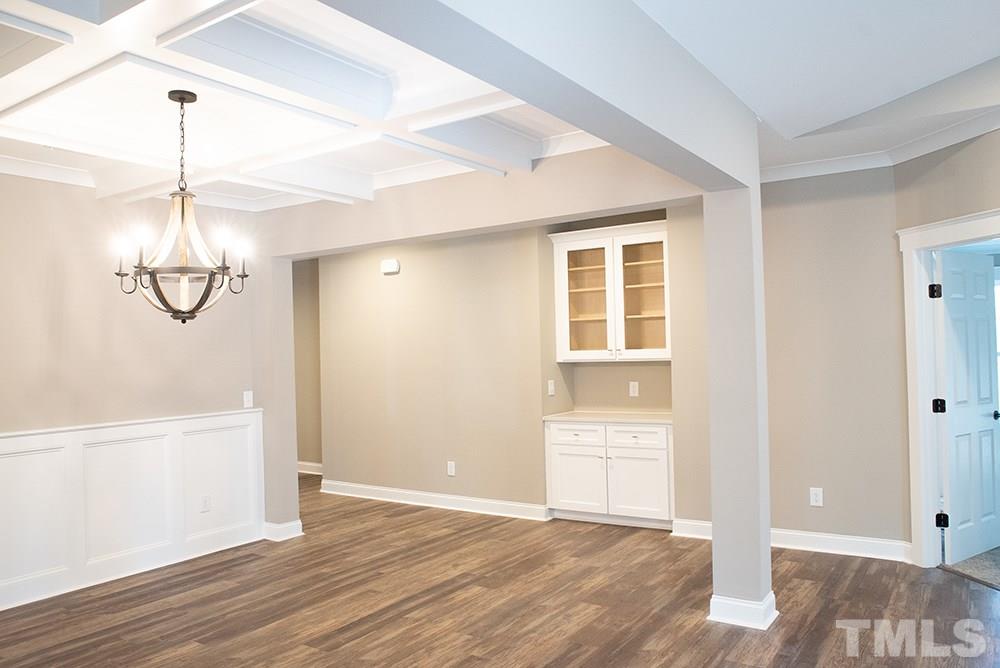 1426 Bowmantown Road Roxboro, NC 27574 - Photo 10 of 28 a view of empty room with wooden floor and ceiling fan