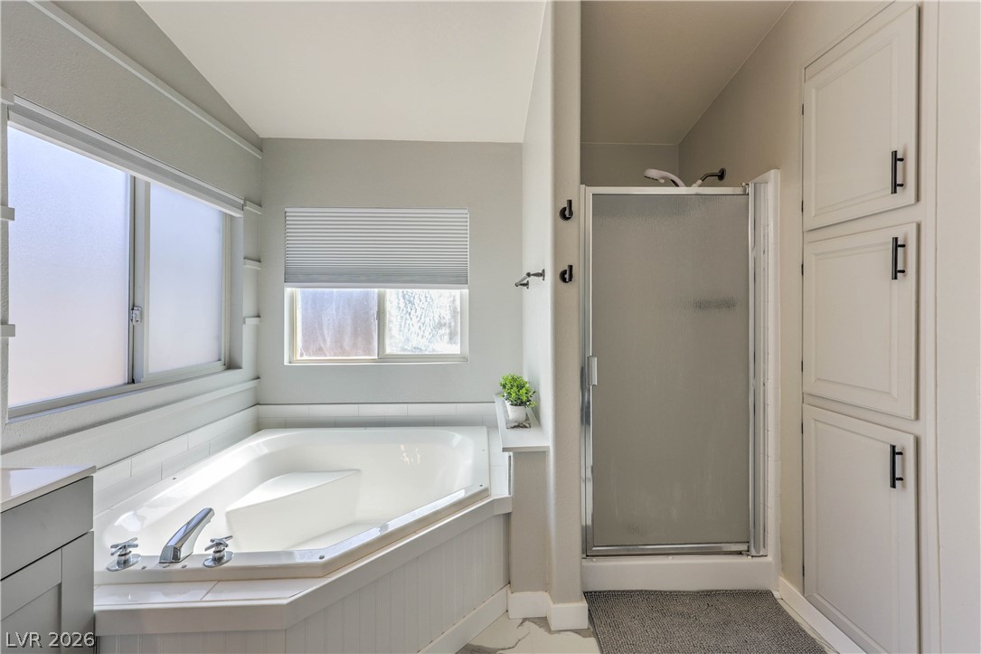 348 Tres Palomas Street Overton, NV 89040 - Photo 21 of 41 Indulge in a corner soaking tub and glass-enclosed shower in this bright, well-appointed bathroom.