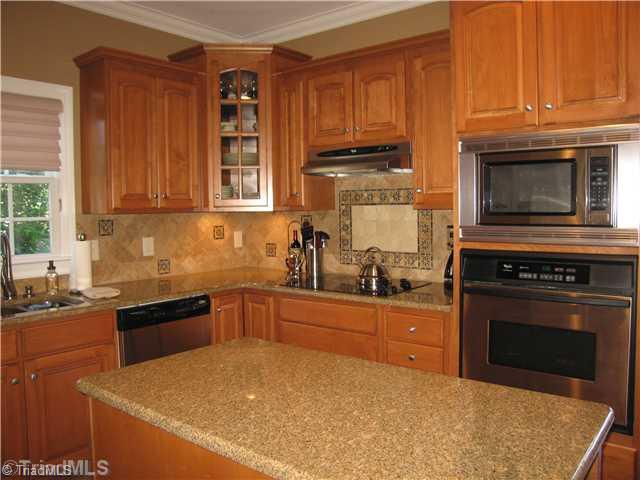 5810 Crutchfield Farm Road Oak Ridge, NC 27310 - Photo 4 of 16 Kitchen. Other features include built-in microwave and oven and a cooktop. This kitchen is delightfully symmetrical with glass cabinets located on either side!
