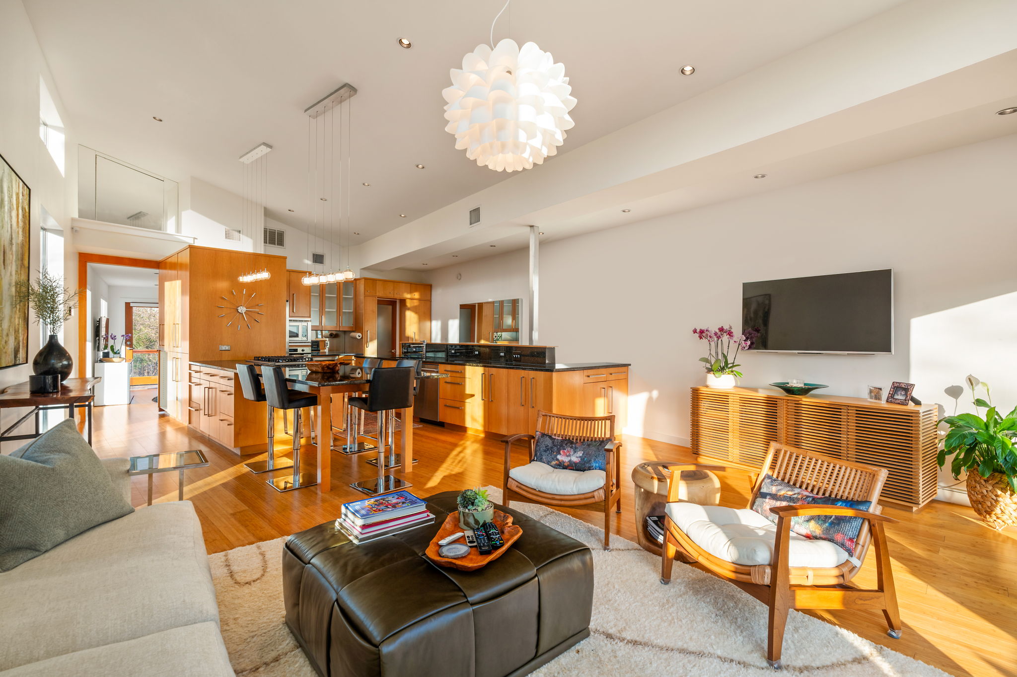 1700 Ravey Street, Unit A Austin, TX 78704 - Photo 12 of 40 Living room featuring light wood-style floors, a chandelier, and a high ceiling