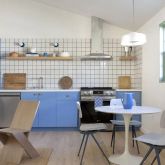 a view of a kitchen with dining area and windows