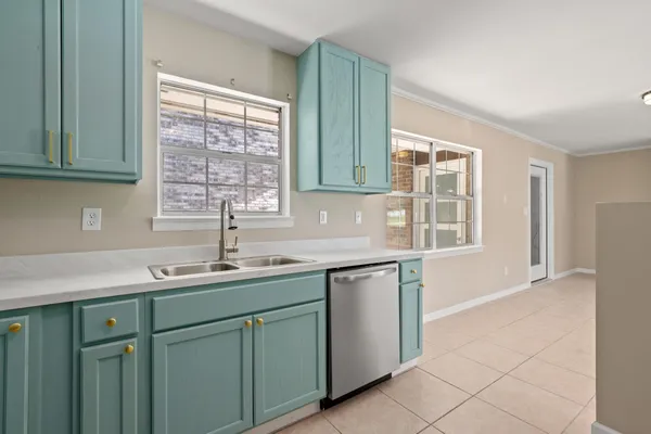 a view of an empty room with a kitchen