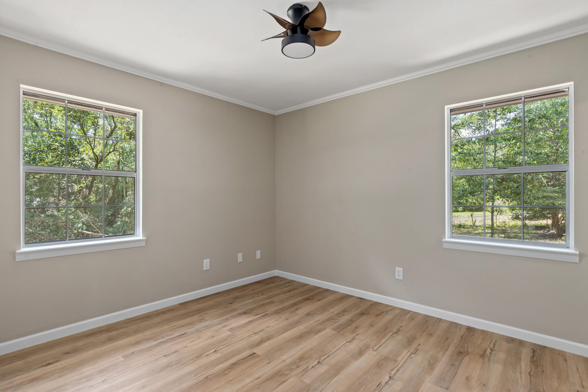 255 Brackin Street, Unit A&B Crestview, FL 32539 - Photo 25 of 70 a view of an empty room with wooden floor and a window