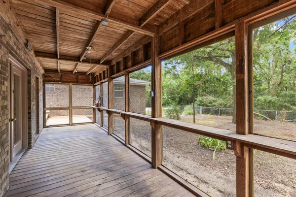 wooden floor in an empty room with a fireplace