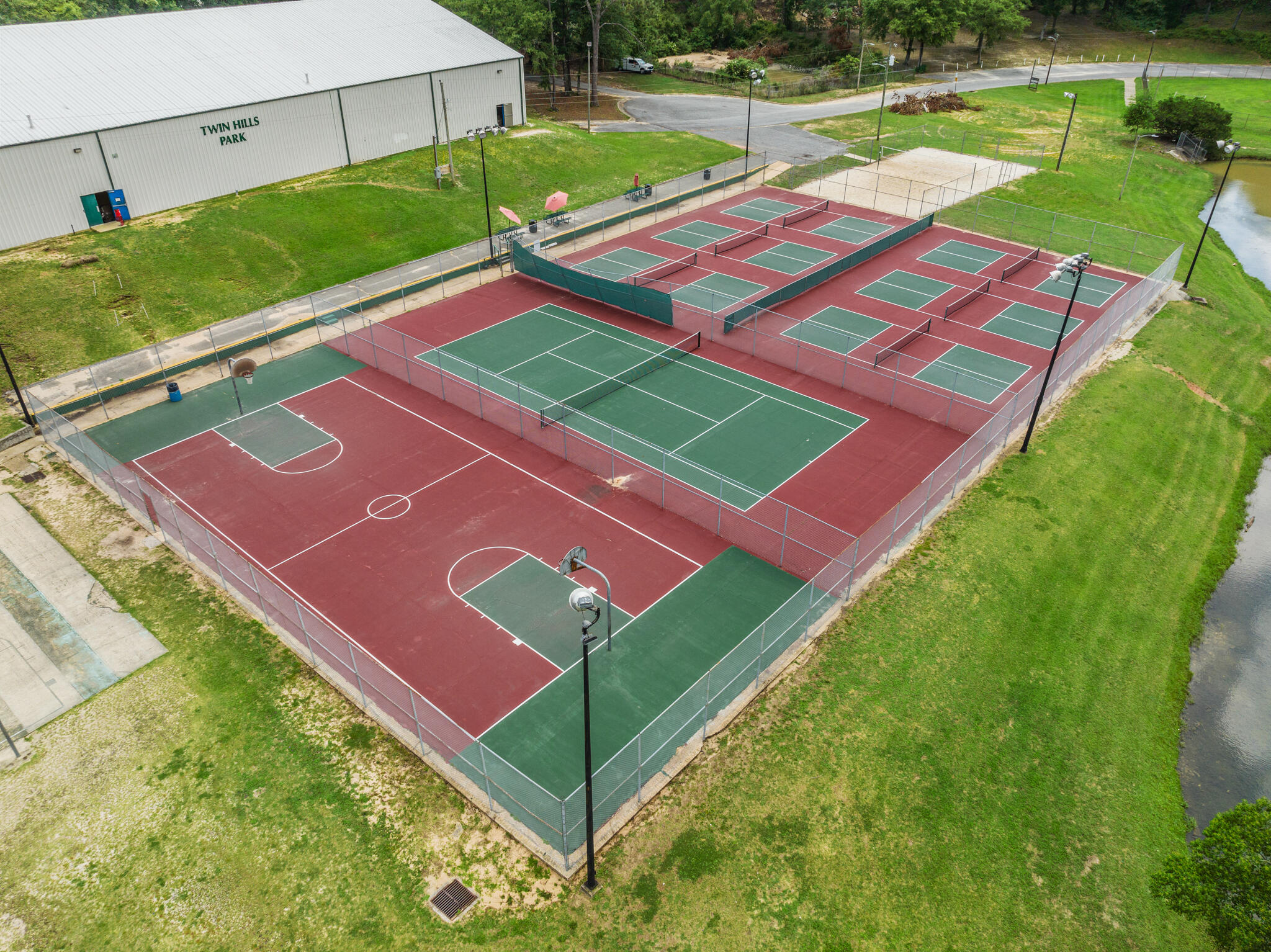 255 Brackin Street, Unit A&B Crestview, FL 32539 - Photo 57 of 70 a view of a tennis ground with a large pool