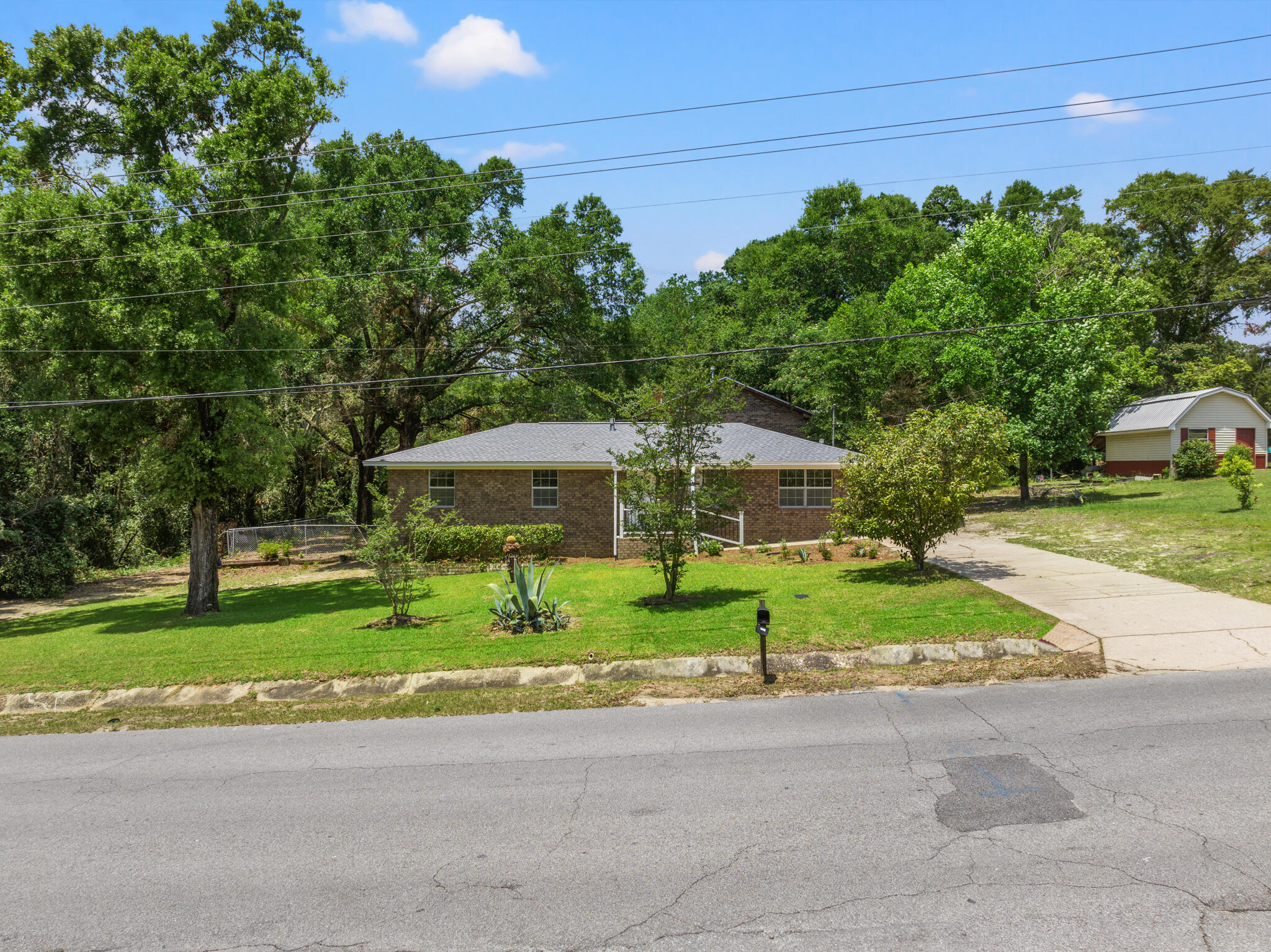 255 Brackin Street, Unit A&B Crestview, FL 32539 - Photo 6 of 70 a yellow house with trees in front of it