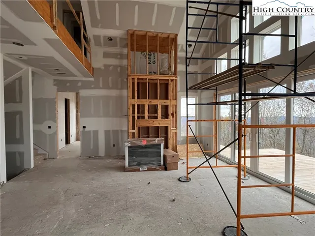 a view of staircase with a rug and a window