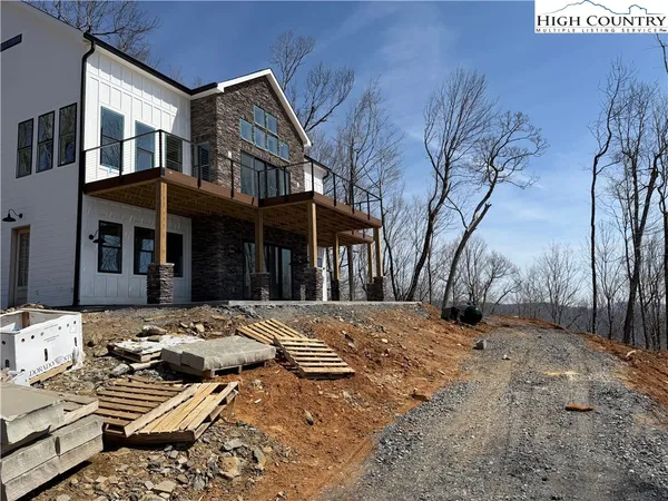 a view of a house with a snow on the side of the road