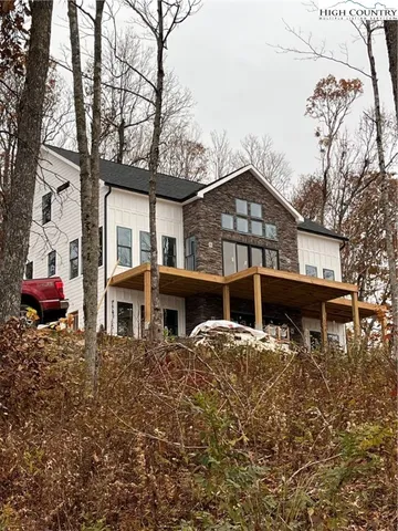 a house that has a tree in front of it