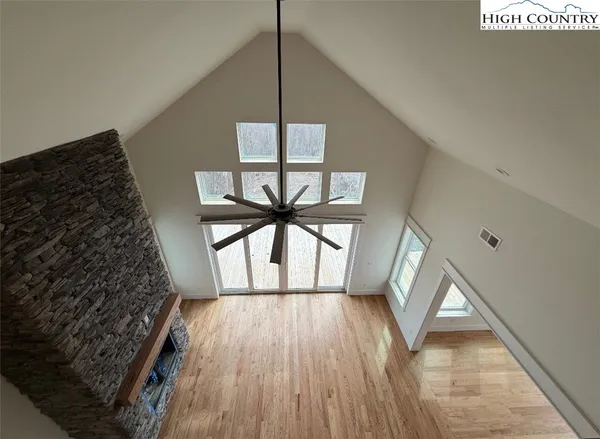 a view of an empty room with a fireplace and a window