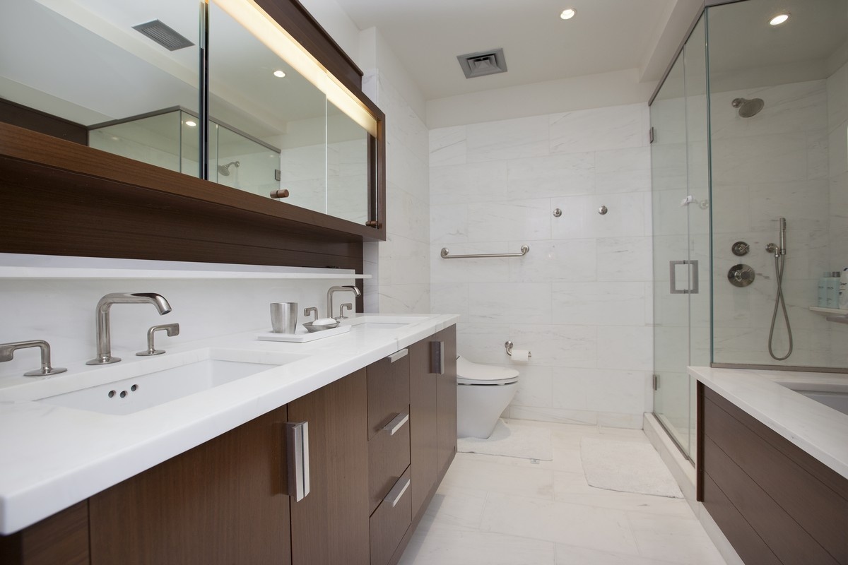 60 Riverside Boulevard, Unit 2802 Manhattan, NY 10069 - Photo 7 of 25 a spacious bathroom with a double vanity sink toilet mirror and shower