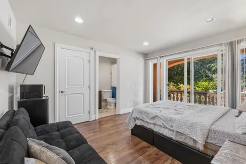 a living room with a bed furniture and a large window