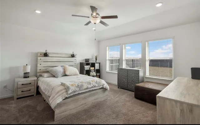 a bedroom with a large bed and a couch