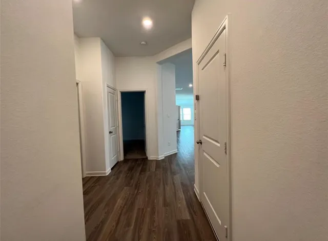 a view of hallway with wooden floor