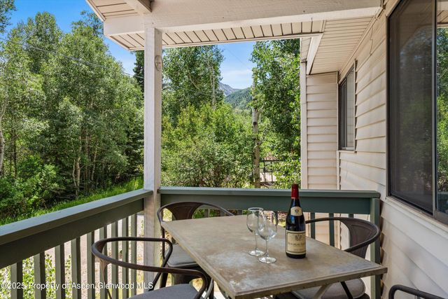 a view of balcony with outdoor seating and wooden floor