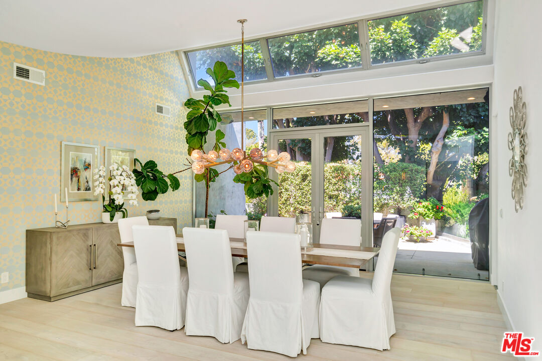 28775 Sea Ranch Way Malibu, CA 90265 - Photo 9 of 21 a dining room with furniture potted plants and wooden floor